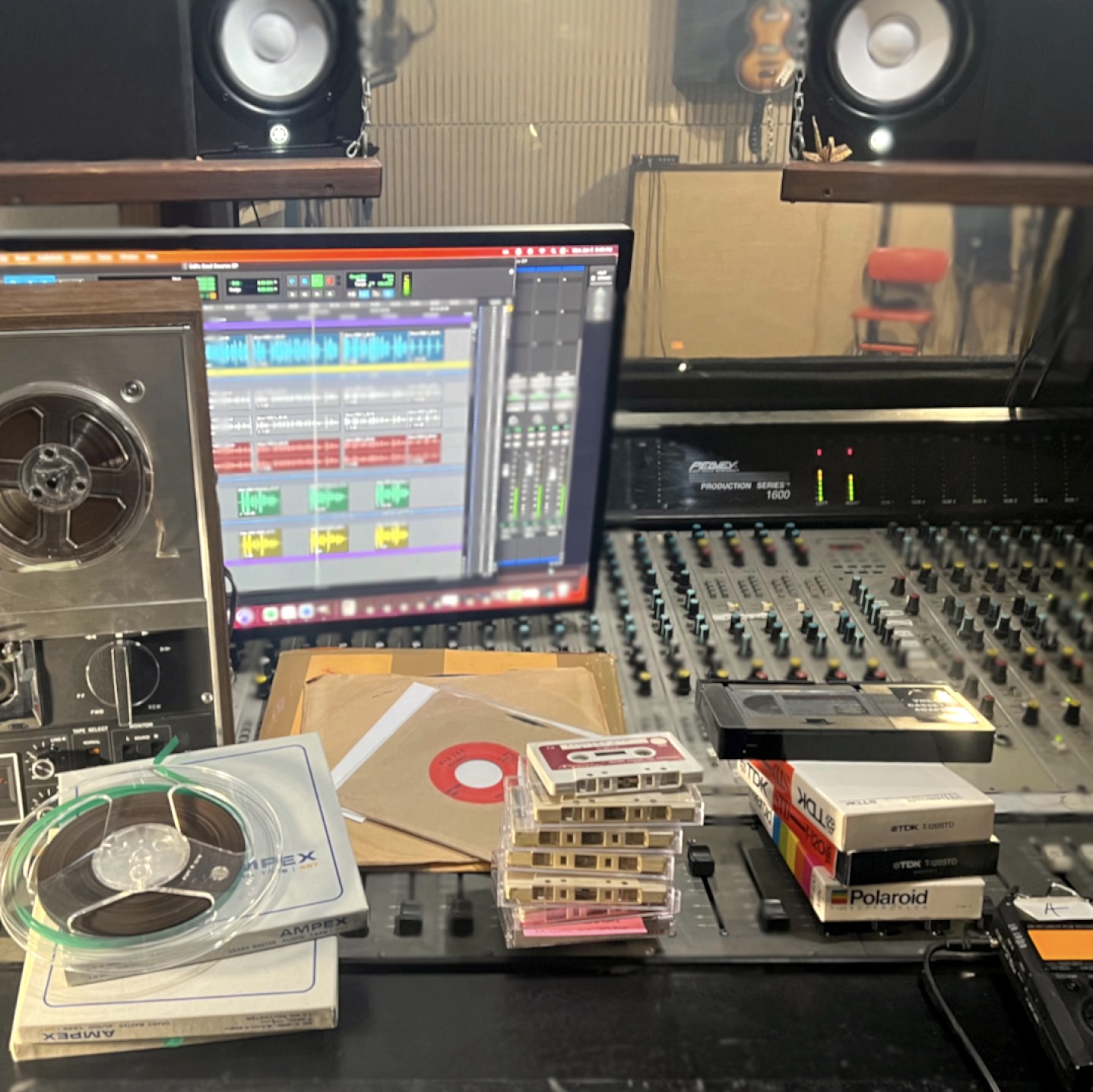 Various tapes - cassette, reels, VHS, and others on studio mixing console format transfer